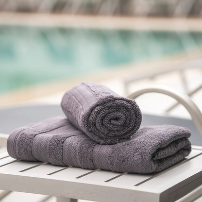 Dow Grey Melluva Turkish cotton towel rolled on a poolside lounger