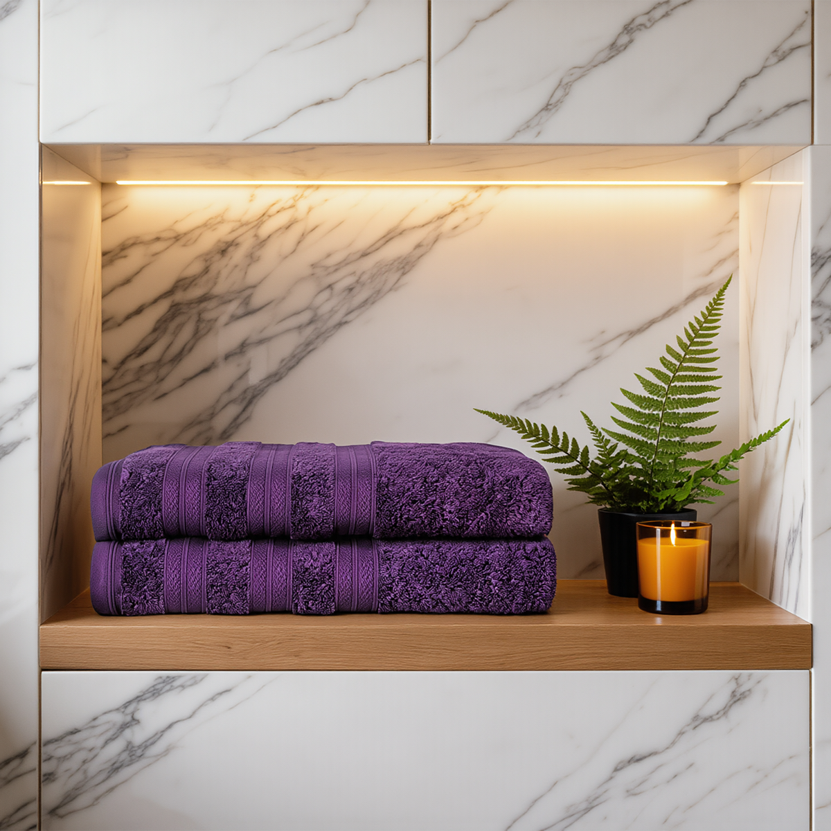 Plum Melluva Turkish cotton towels, set of 2, folded on a bathroom shelf
